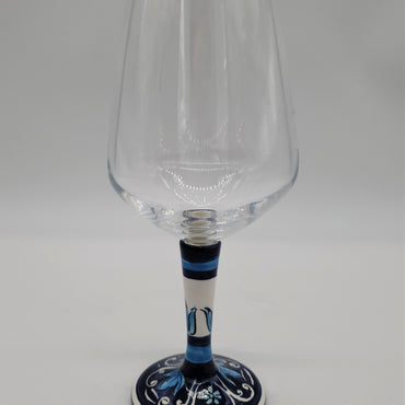 Glass for Wine Ceramic and White Graffiti Glass on a Blue Background