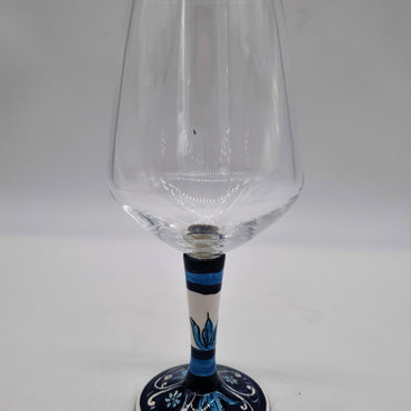 Glass for Wine Ceramic and White Graffiti Glass on a Blue Background