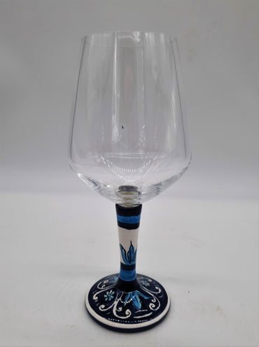 Glass for Wine Ceramic and White Graffiti Glass on a Blue Background