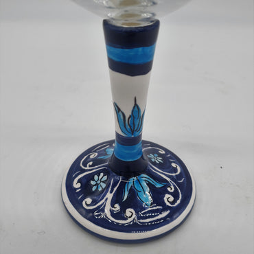 Glass for Wine Ceramic and White Graffiti Glass on a Blue Background
