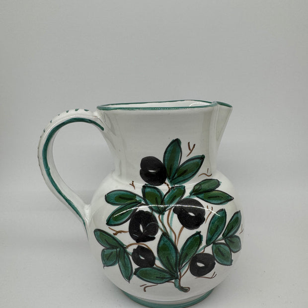 Pitcher olives white background