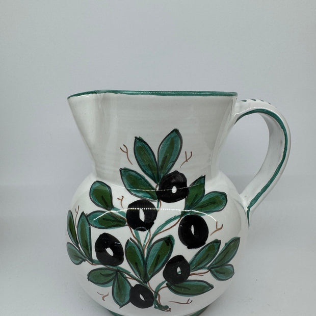 Pitcher olives white background