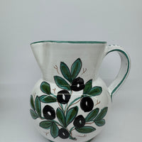 Pitcher olives white background