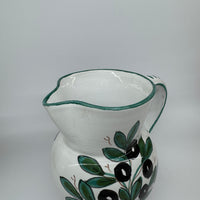 Pitcher olives white background