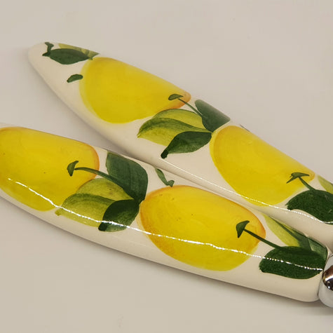 Pair of serving cutlery with lemon decoration