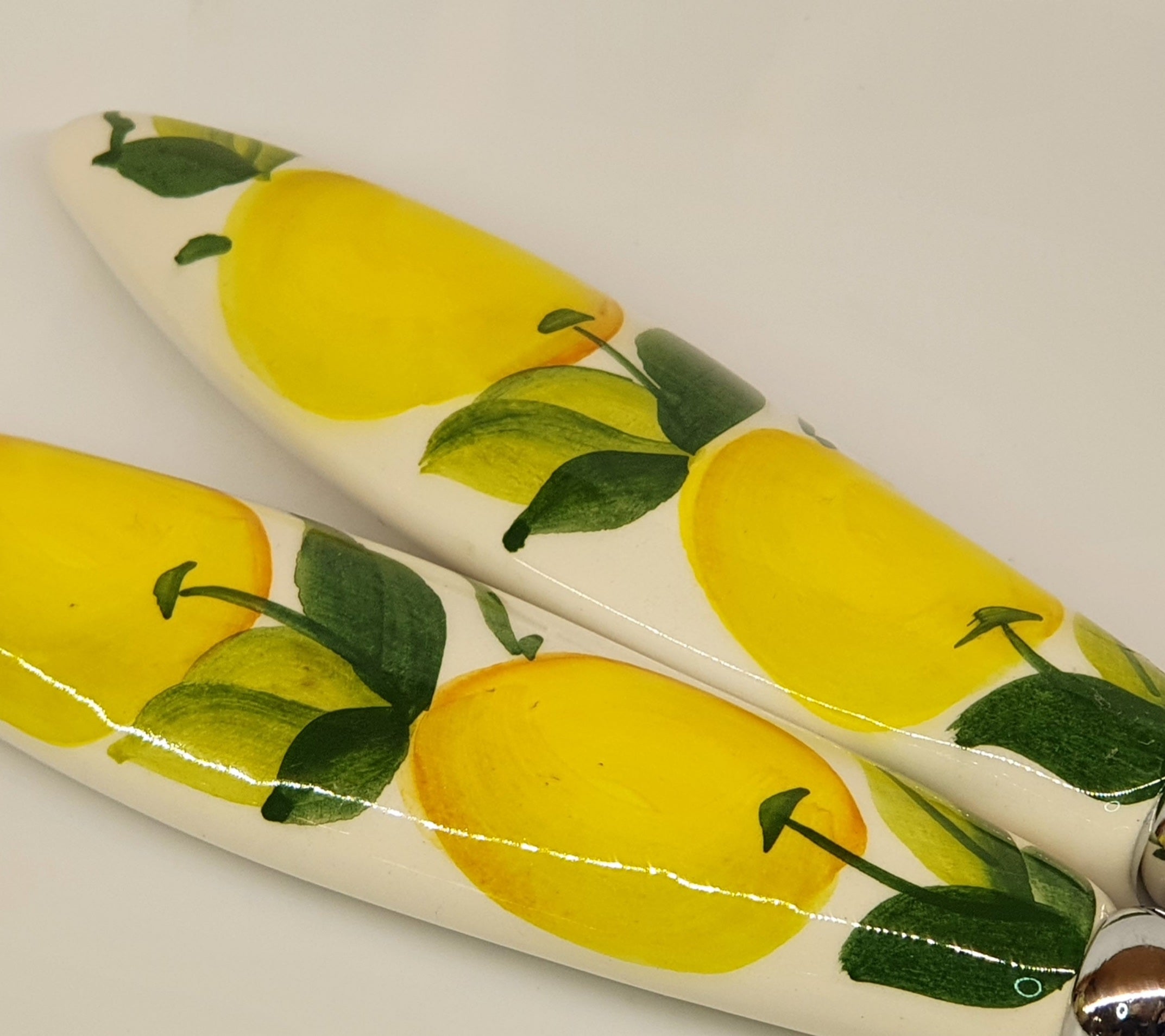 Pair of serving cutlery with lemon decoration
