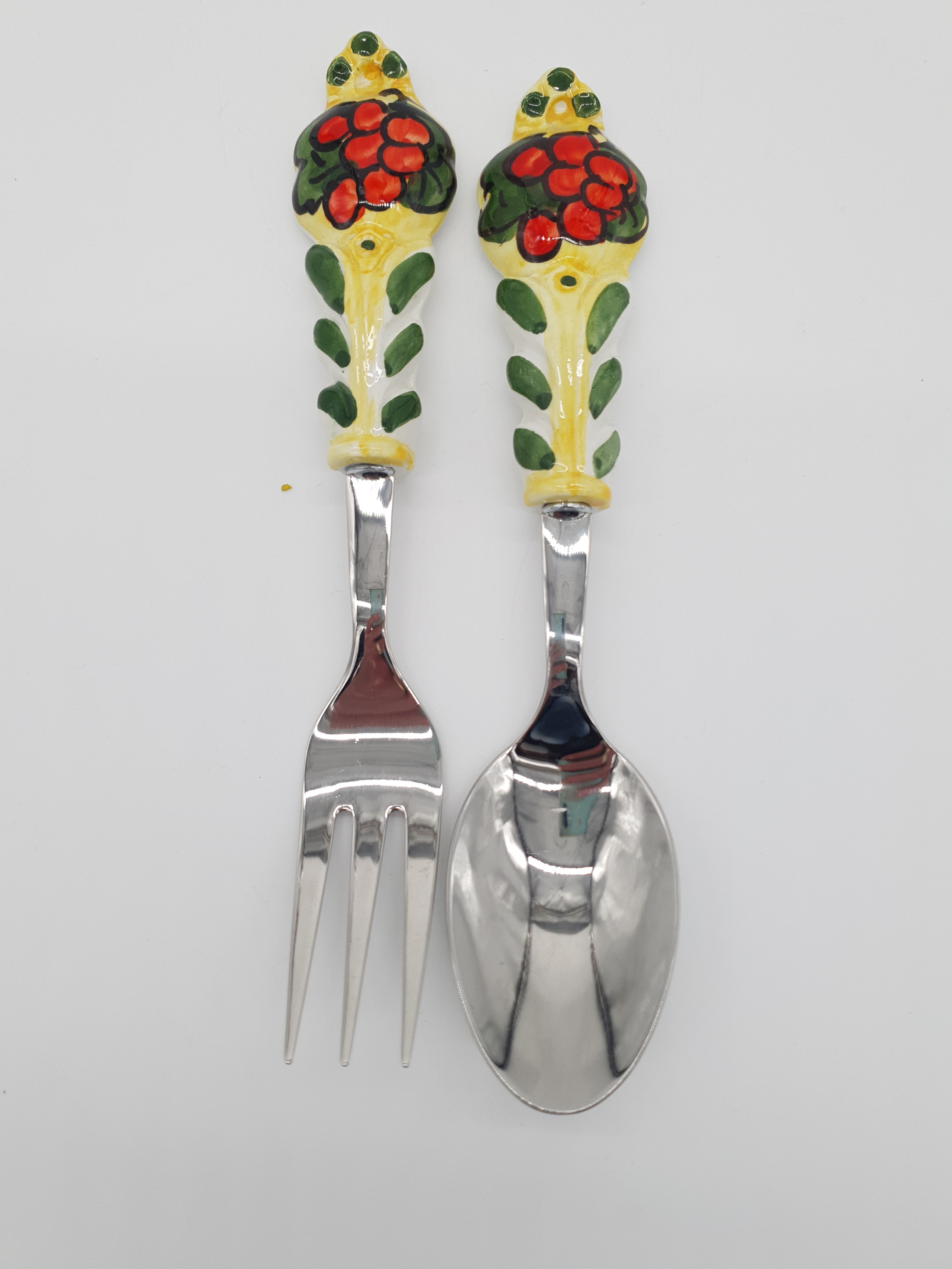 Pair of Cutlery for Serving Meat Red Grapes Yellow Background Steel and Ceramic