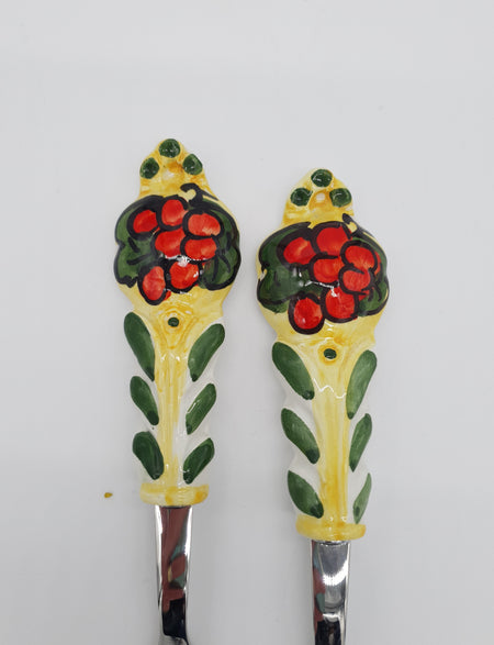 Pair of Cutlery for Serving Meat Red Grapes Yellow Background Steel and Ceramic