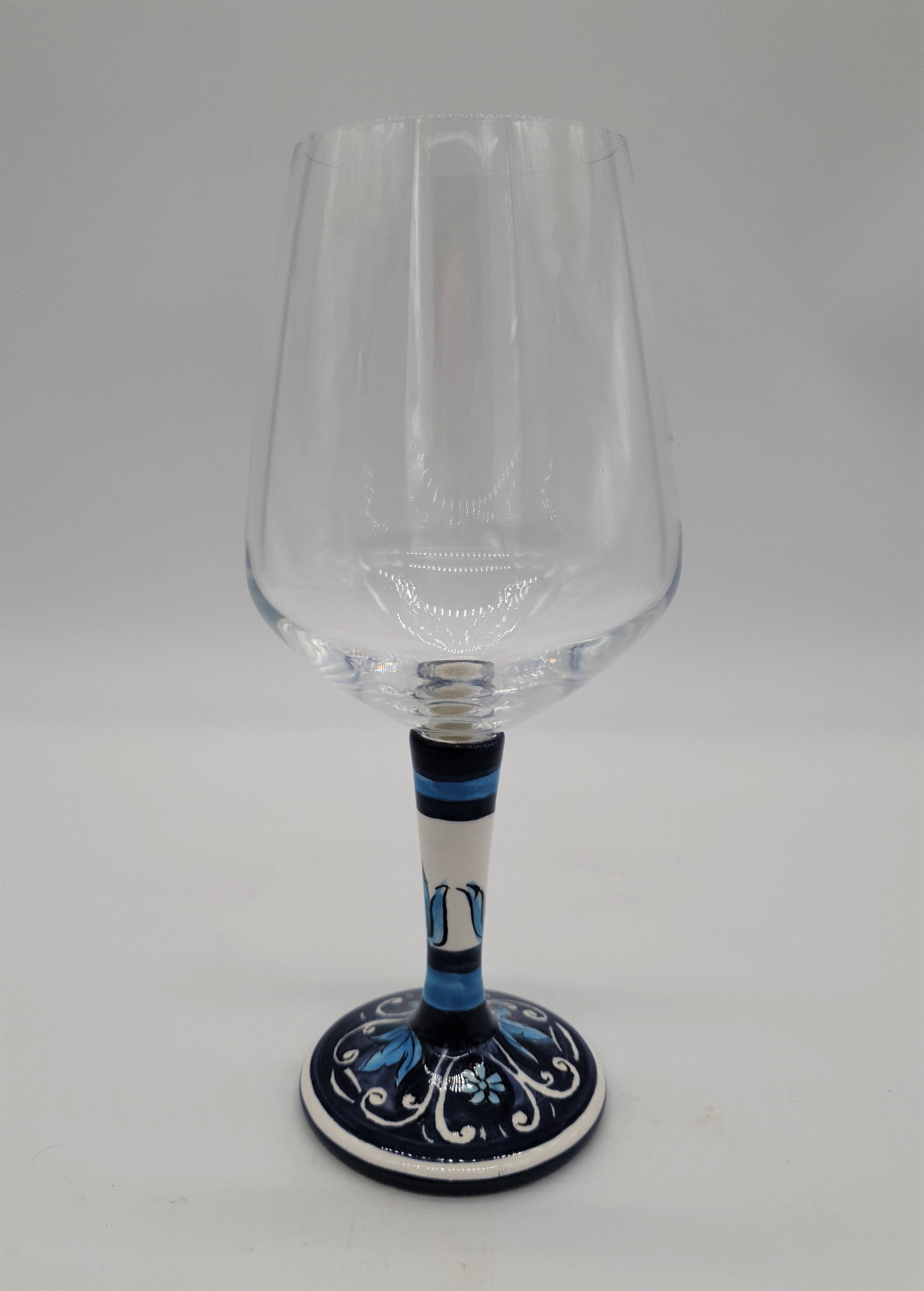 Glass for Wine Ceramic and White Graffiti Glass on a Blue Background