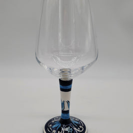 Glass for Wine Ceramic and White Graffiti Glass on a Blue Background