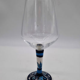 Glass for Wine Ceramic and White Graffiti Glass on a Blue Background