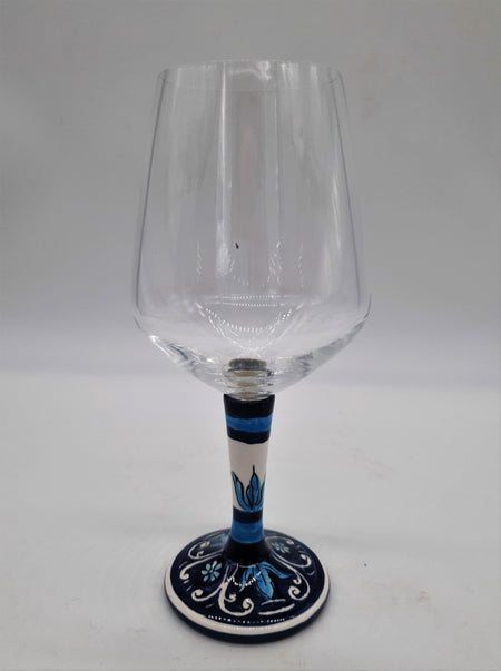 Glass for Wine Ceramic and White Graffiti Glass on a Blue Background