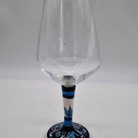 Glass for Wine Ceramic and White Graffiti Glass on a Blue Background