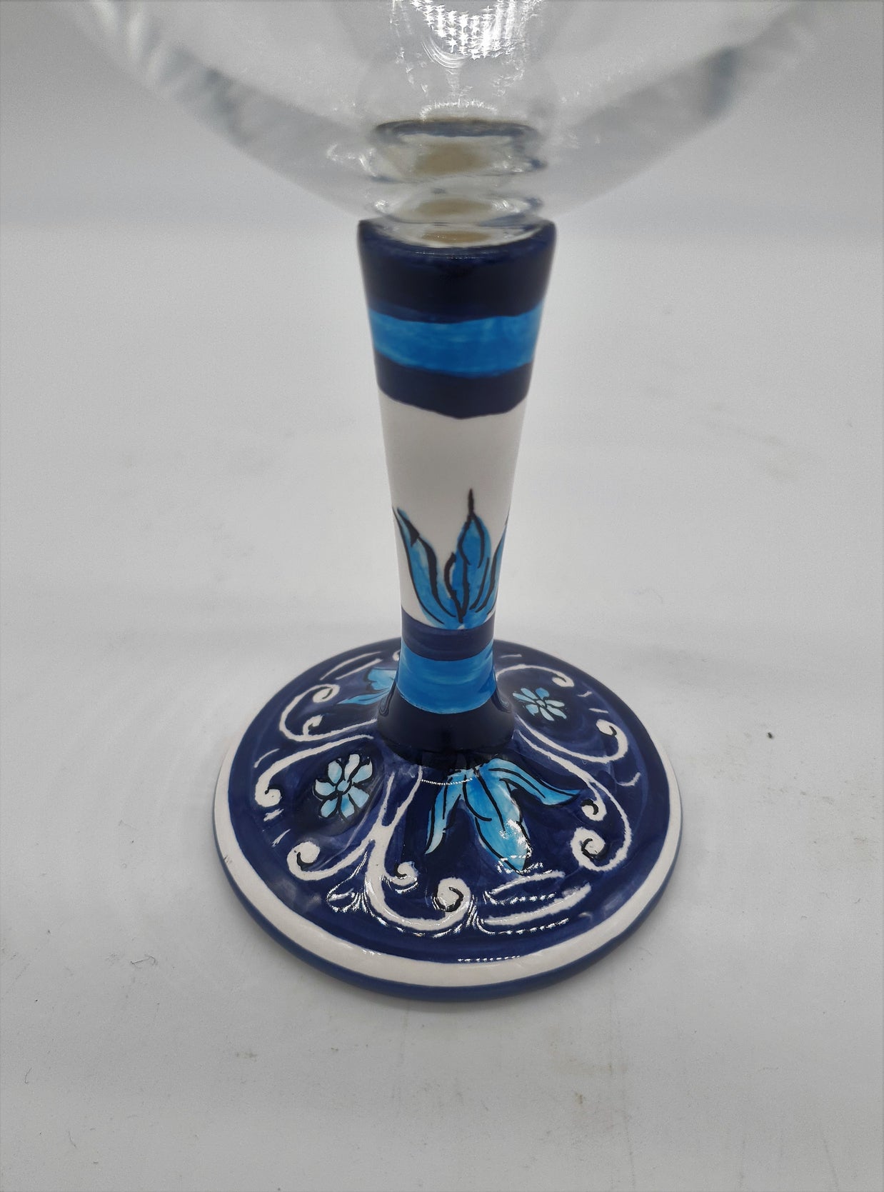 Glass for Wine Ceramic and White Graffiti Glass on a Blue Background