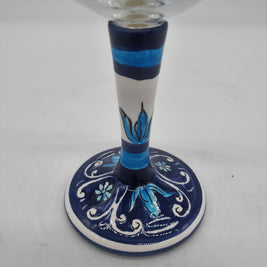 Glass for Wine Ceramic and White Graffiti Glass on a Blue Background