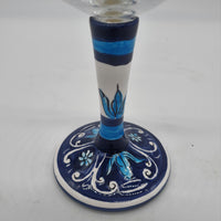 Glass for Wine Ceramic and White Graffiti Glass on a Blue Background