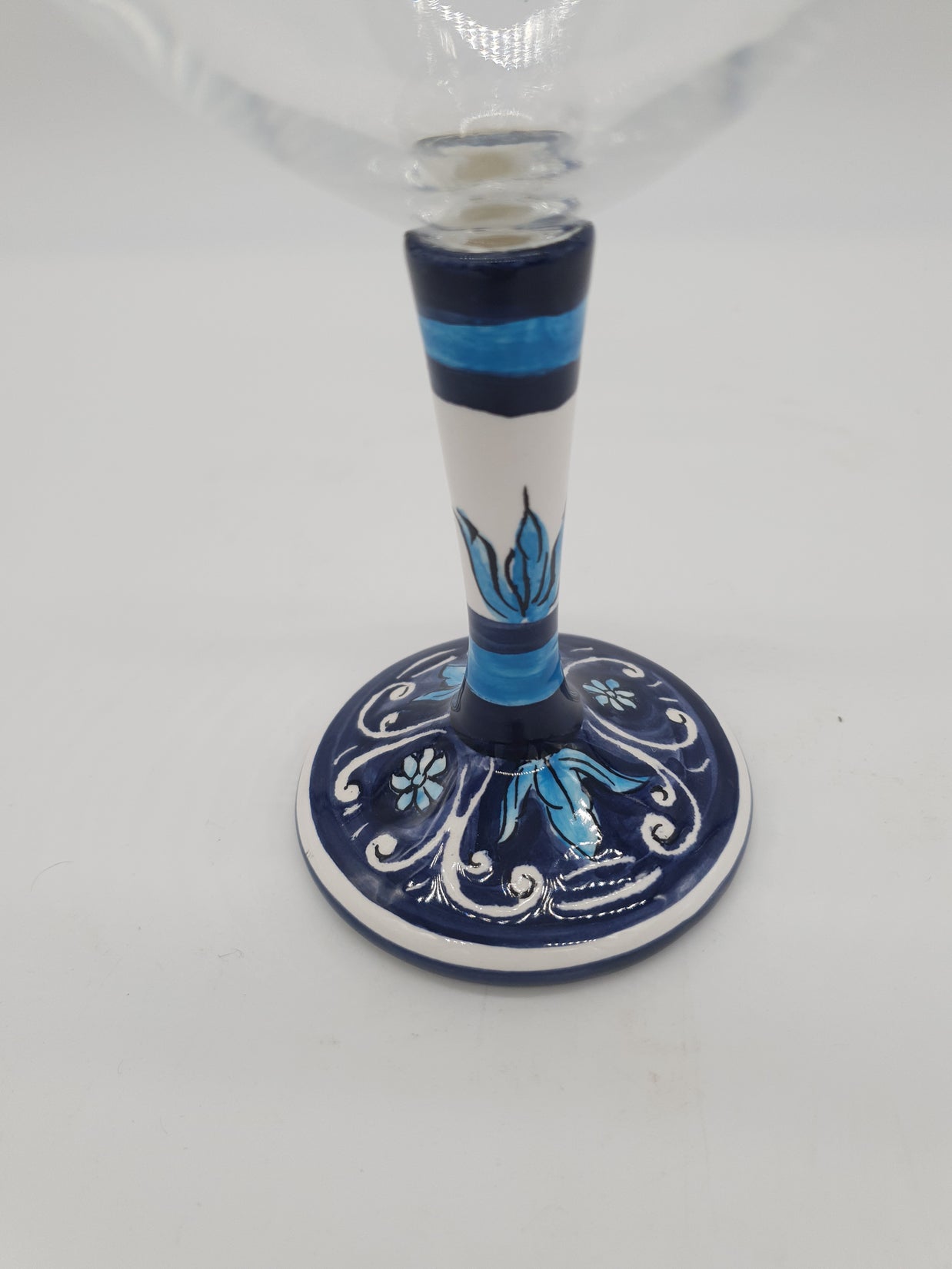 Glass for Wine Ceramic and White Graffiti Glass on a Blue Background