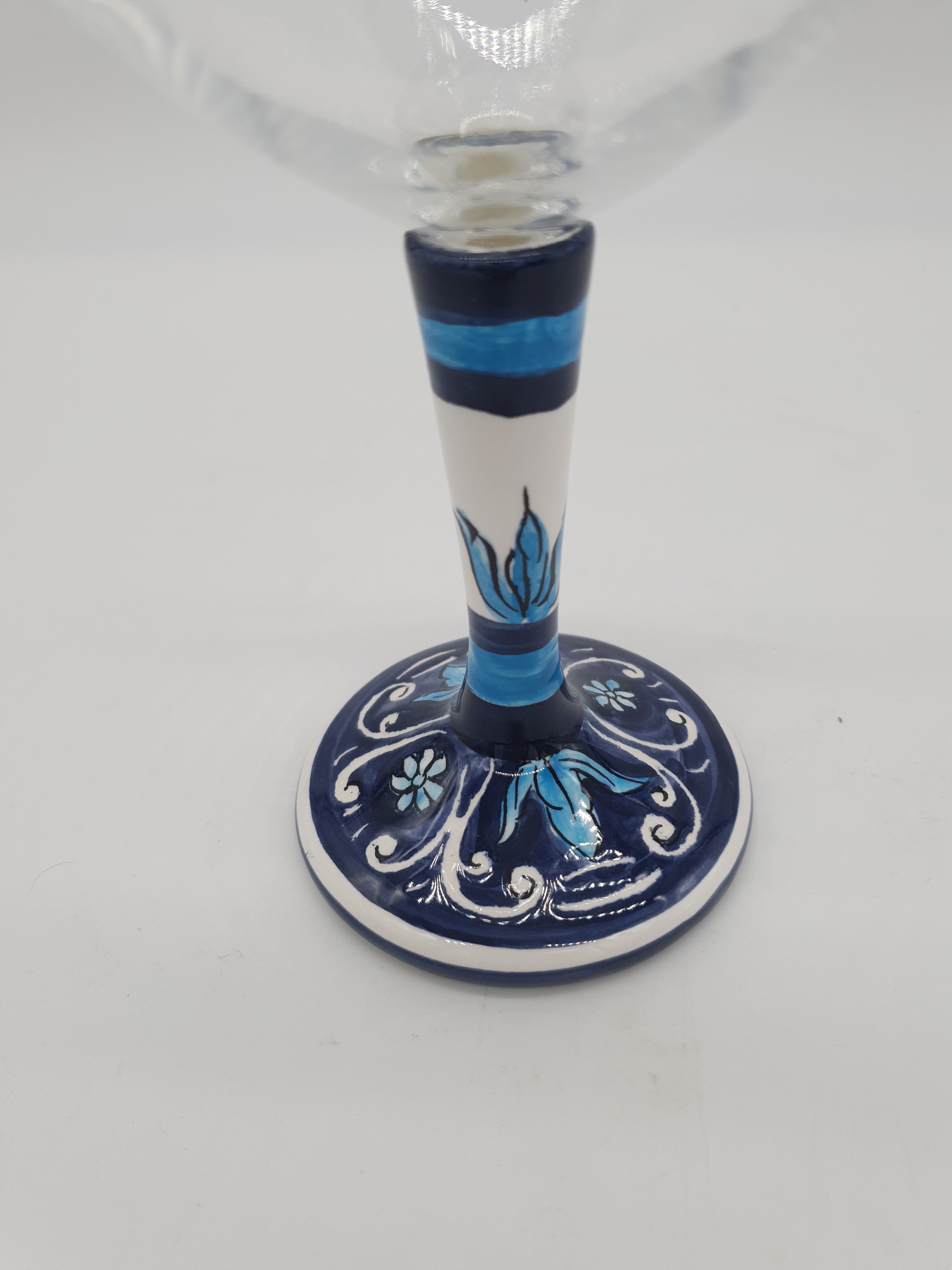 Glass for Wine Ceramic and White Graffiti Glass on a Blue Background