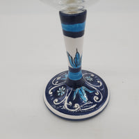 Glass for Wine Ceramic and White Graffiti Glass on a Blue Background