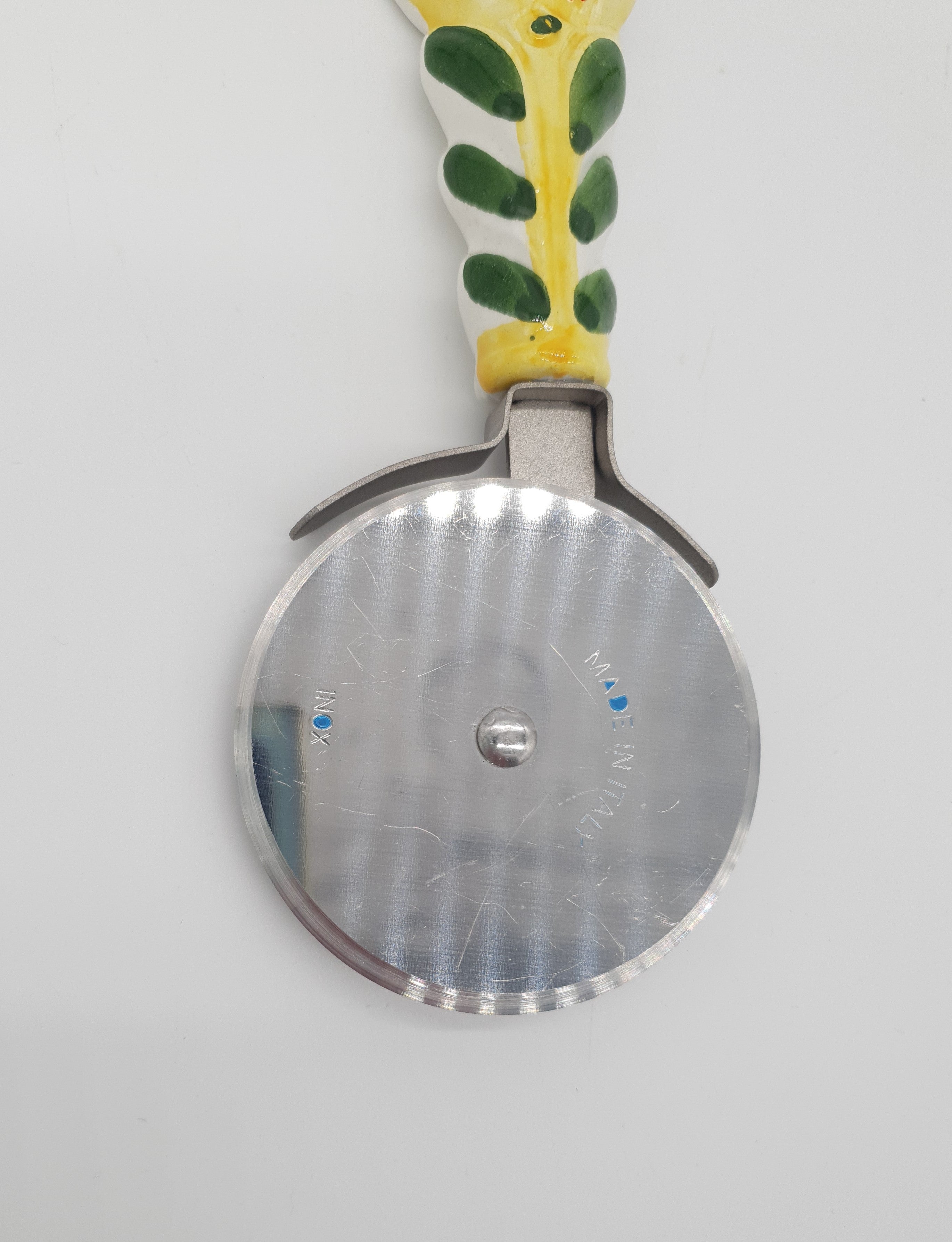 Wheel Pizza Cutter Pepper Decor Yellow Background Steel and Ceramic